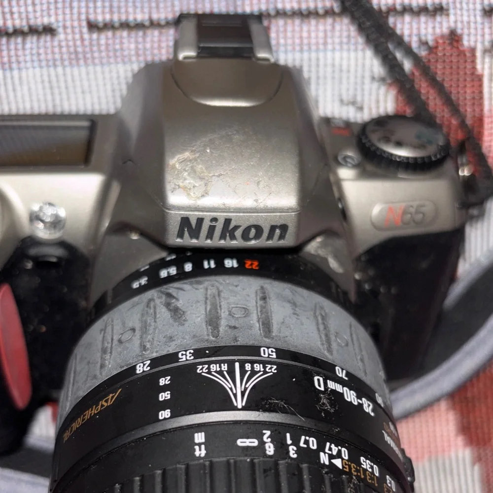 Nikon Silver and Black DSLR with Zoom Lens and Strap